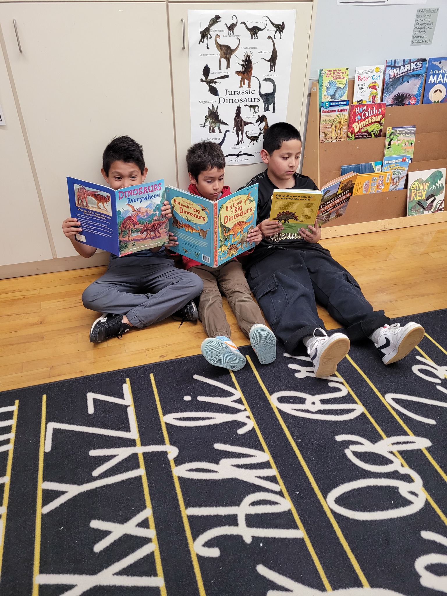 three kids reading books